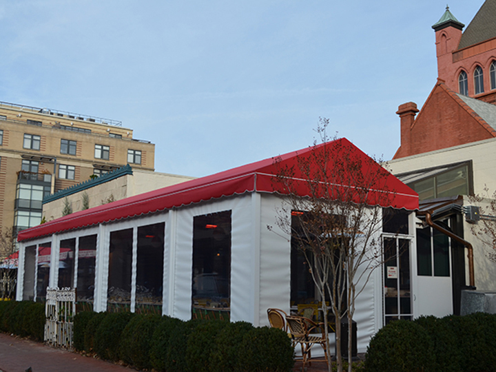 red canopy with white roll down screens for restaurant seating area